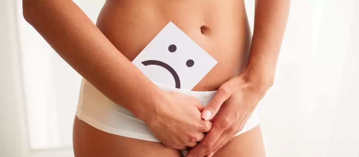 Vaginal or urinary infection and problems concept. Young woman holds paper with SOS above crotch.